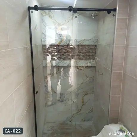 Cabina de baño en vidrio templado transparente con herrajes negros, puerta corrediza – CA-022 | Aluminazca Medellín
